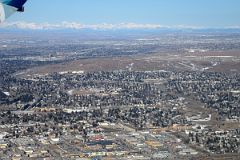 02D Calgary Is Spread Out With The Rocky Mountains In The Distance From The Air In Winter